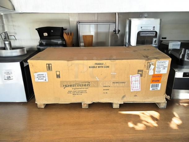 Factory-sealed Henny Penny HHC900.24 full-height heated holding cabinet on casters, solid back, in original packaging.