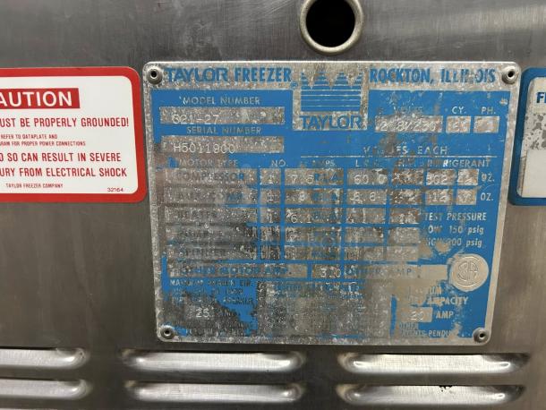 Metallic label on Taylor Y339-27 soft serve ice cream machine, showing model details and electrical warnings, 208/230V. Condition: not tested.
