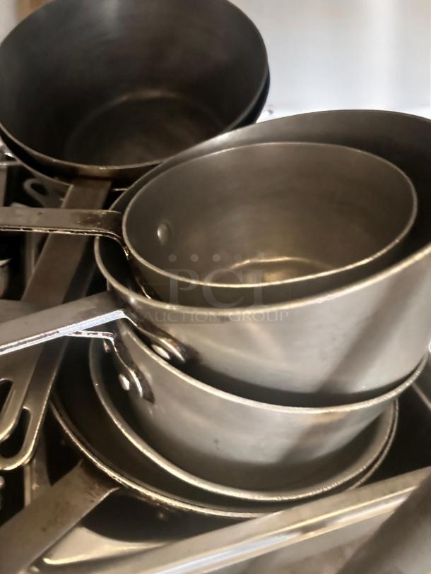 Lot of stainless steel commercial sauce pans with handles, in very good condition. Assorted nesting sizes. NSF certified.
