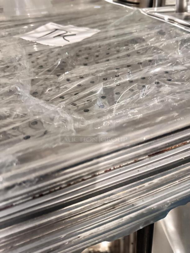 Lot of full-size stainless steel hotel pans, both solid and perforated, in superb condition, NSF certified, Commercial Foodservice brand.