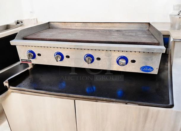Globe 48" Commercial Gas Griddle in excellent condition, four blue knobs, stainless steel surface, fully tested.