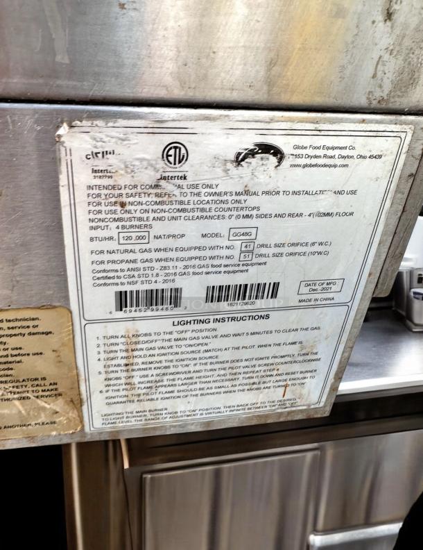 Alt Text: Globe 48" Commercial Gas Griddle with manufacturer label, model CG486, for professional use. Excellent condition.