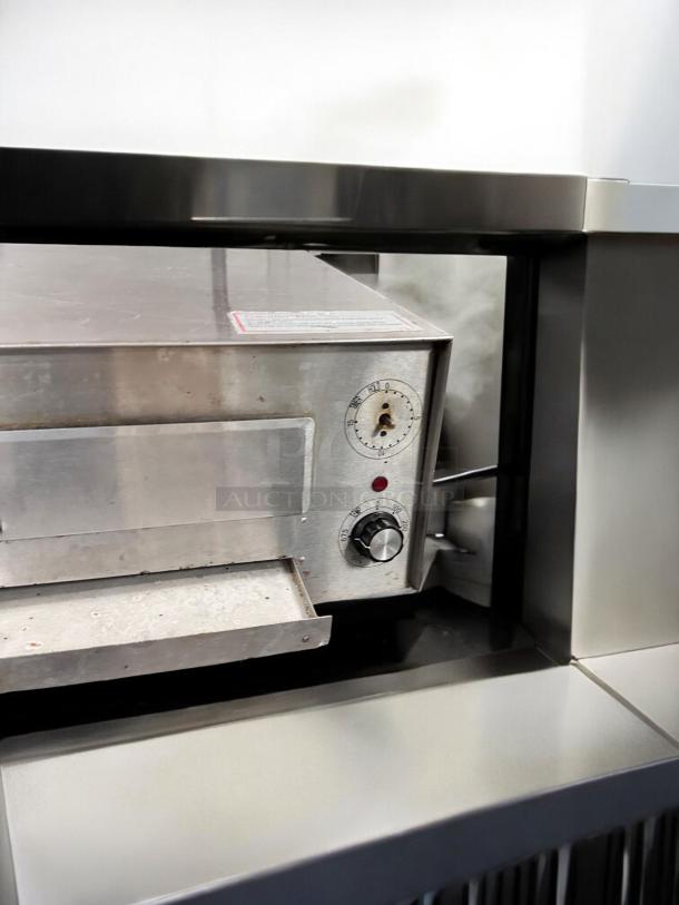 Commercial countertop electric pizza oven, stainless steel, excellent condition, fully tested, operational controls visible.