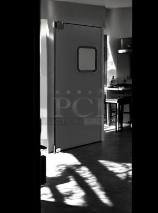 Eliason single swing traffic door, 36"W x 80"H, heavy-duty black finish, excellent condition, fully tested and operational.