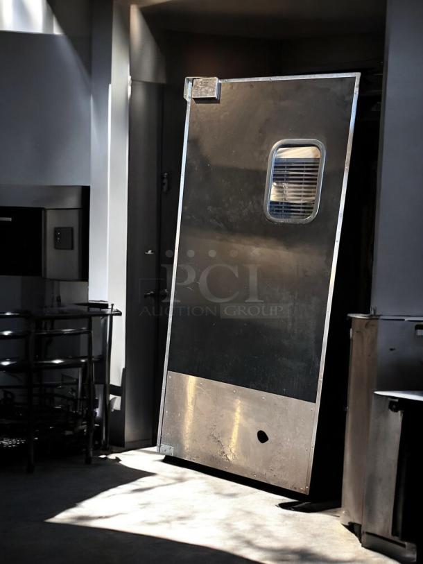 Eliason single swing traffic door, 36"W x 80"H, heavy-duty black finish, excellent condition, tested and operational.