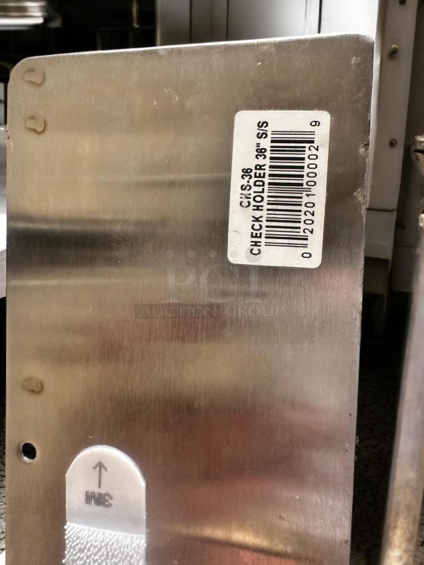 CIS-36 stainless steel check holder, 36", excellent condition, tested working. Label shows model and size details.