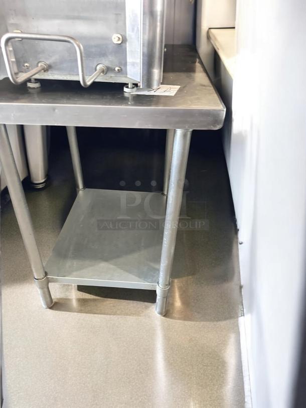 Stainless steel work table, 24"W x 30"D x 34"H, with undershelf. Excellent condition, tested and fully functional.