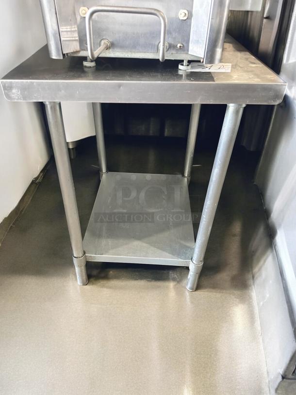 Commercial stainless steel work table, 24"W x 30"D x 34"H, excellent condition, with undershelf, fully tested.