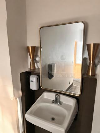 Rectangular wall mirror with gold edge trim, excellent condition, commercial grade, ready to install in restroom.