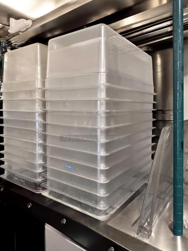 Stacked polycarbonate food storage pans with lids, excellent condition, quantity 22, stackable, fully tested, operational.