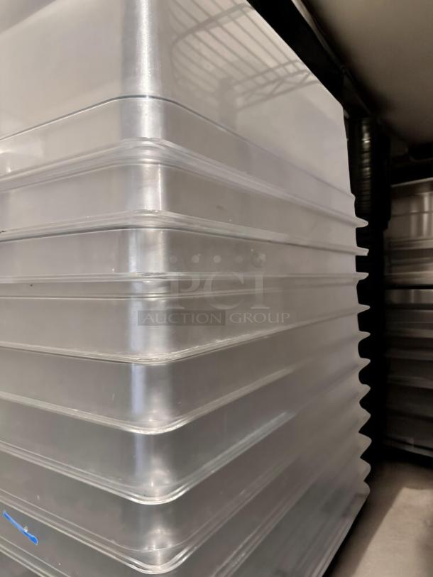Stack of 22 polycarbonate food storage pans with lids, excellent condition, fully tested, stackable, commercial use.