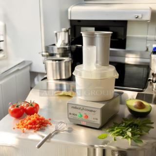 Robot Coupe R101 commercial food processor, excellent condition, fully tested and operational, shown on stainless steel surface.