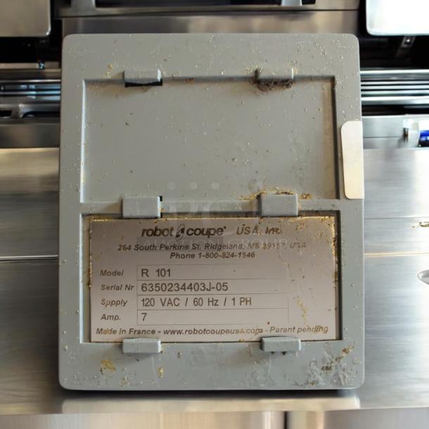 Robot Coupe R101 Commercial Food Processor label, showing model, serial number, voltage, and contact details.