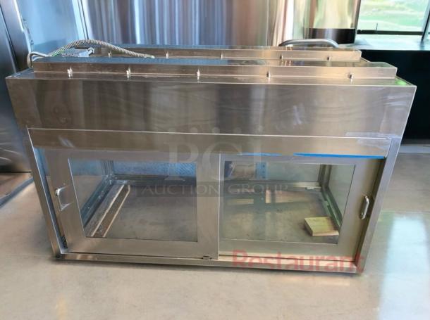 Stainless steel heated display cabinet in excellent condition, fully tested and operational, features glass doors and sturdy construction.