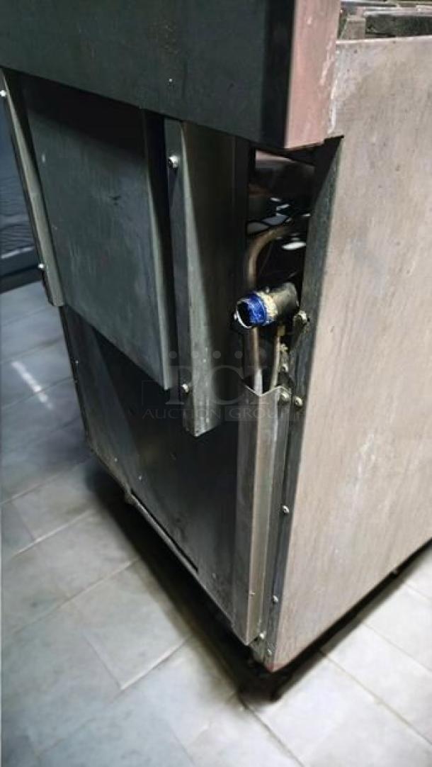 Commercial 4-burner gas range with oven in excellent condition, unbranded. Side view showcasing operational components.
