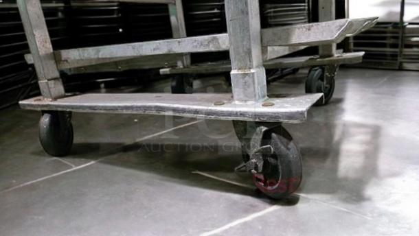 Stainless steel mobile bun/sheet pan rack with solid top work table, excellent condition, fully operational.