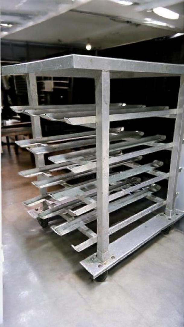 Stainless steel mobile bun/sheet pan rack table with solid top, excellent condition, fully tested, unbranded commercial use.