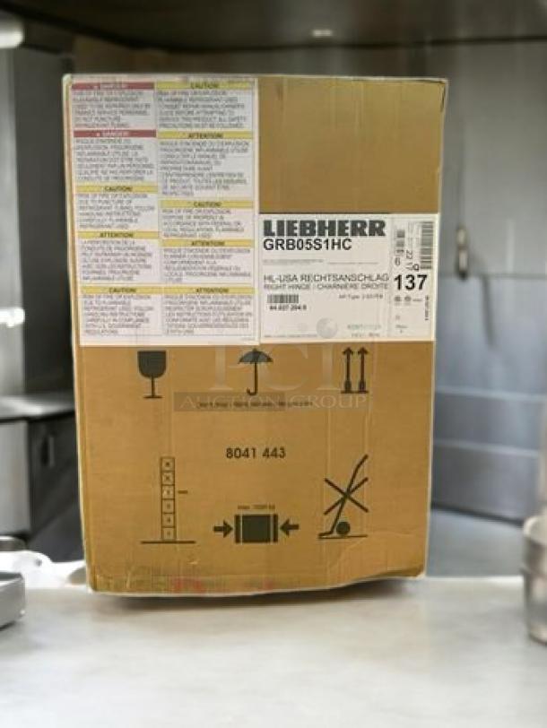 Brand new Liebherr GRB05S1HC bottle cooler in original box. Model label and handling instructions visible. Fully operational.