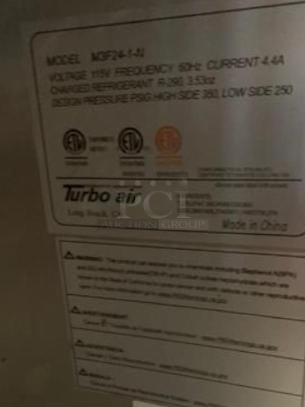 Turbo Air MGF24-1-N single solid door freezer, 24" wide, 115V, excellent condition. Label shows model and technical details.