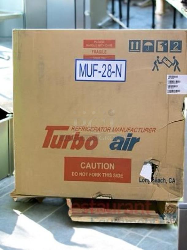 Turbo Air MUF-28-N under-counter freezer in excellent condition, packaged in original shipping box with caution and handling labels.