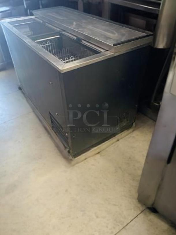Turbo Air TBC-50SB-N6 bottle cooler, 50" wide, in excellent condition. Features dual sliding doors, stainless steel exterior, 115V.
