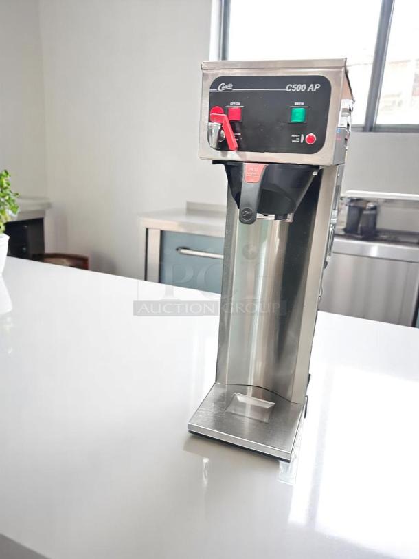 Curtis C500 AP Coffee Brewer in excellent condition, 120V, tested and working. Features include stainless steel design and control panel.