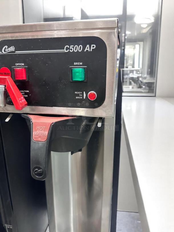 Curtis C500 AP Coffee Brewer, excellent condition, 120V, labeled controls, tested and working, stainless steel finish.