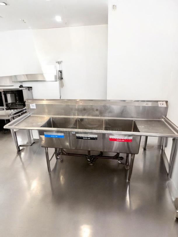 GSW stainless steel 3-compartment sink with dual drainboards, excellent condition, fully tested, labeled water lines.