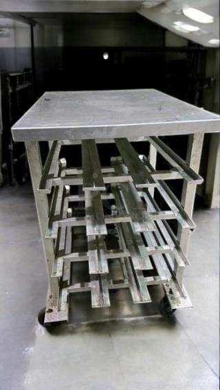 Stainless steel mobile bun/sheet pan rack table, excellent condition, solid top, fully operational, unbranded commercial use.