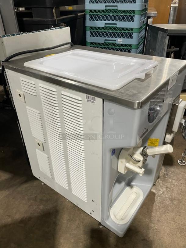 Carpigiani 191 SP/US/E P stainless steel soft serve machine, single flavor, 208-230V 3 Phase, with mixer attachment, on legs.