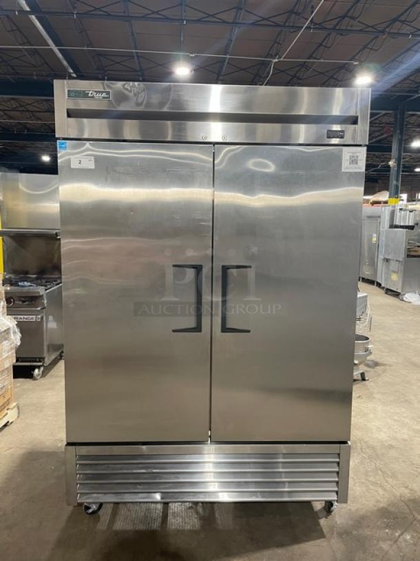 True commercial stainless steel 2-door reach-in freezer, model T-49F-HC. Features poly-coated wire racks, on casters.