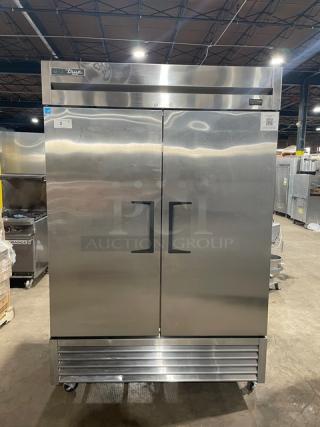 True commercial stainless steel 2-door reach-in freezer, model T-49F-HC. Features poly-coated wire racks, on casters.