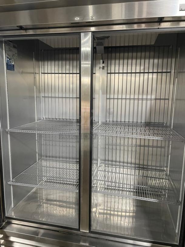 True T49FHC commercial stainless steel 2-door freezer with poly-coated wire racks, on casters, excellent condition.