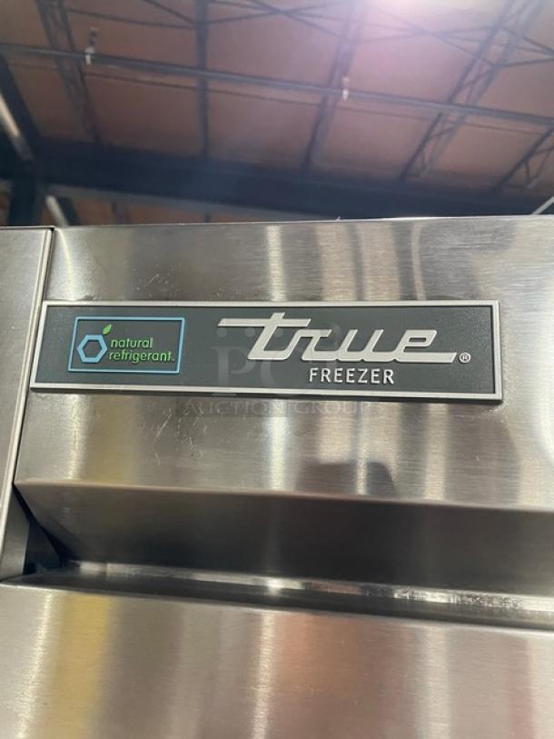 True T49FHC commercial stainless steel 2-door freezer, with poly-coated wired racks, on casters, model SN 10403541.