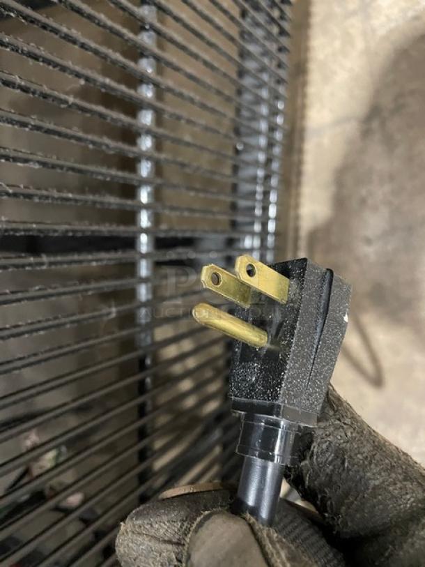 Close-up of a power plug for a True T49FHC commercial freezer, showing sturdy prongs and durable casing.