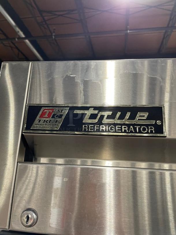 True T-23 stainless steel single door commercial refrigerator, model T23, features poly coated rack and casters, in good condition.
