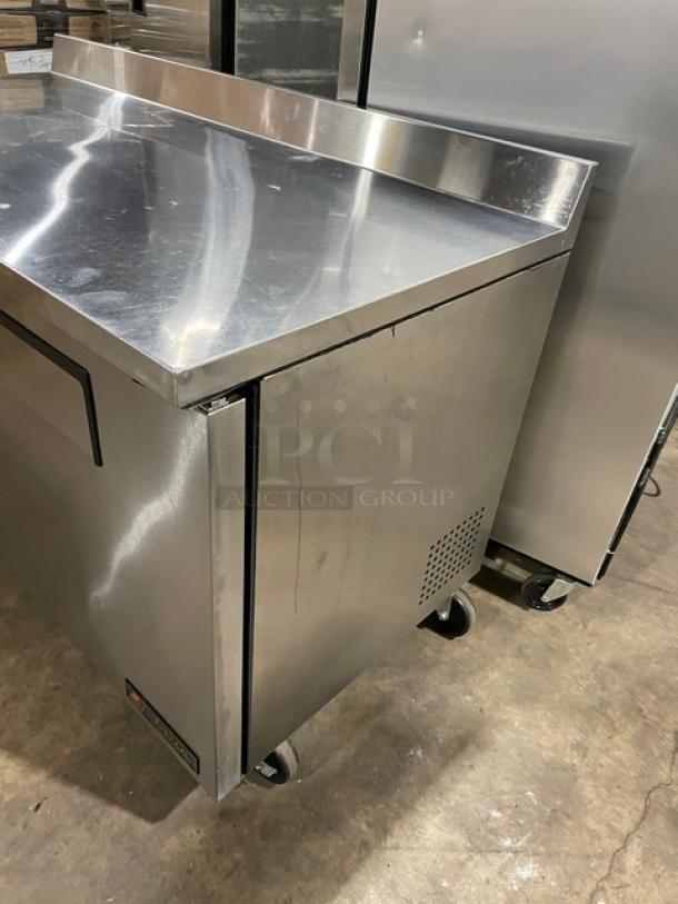 True TWT-60 stainless steel 2-door worktop refrigerator with backsplash, poly-coated rack, on casters. Energy Star Certified.