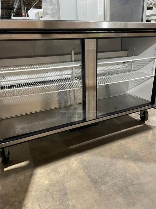 True TWT-60 stainless steel 2-door worktop refrigerator with backsplash, poly coated racks, on casters. Energy Star certified.