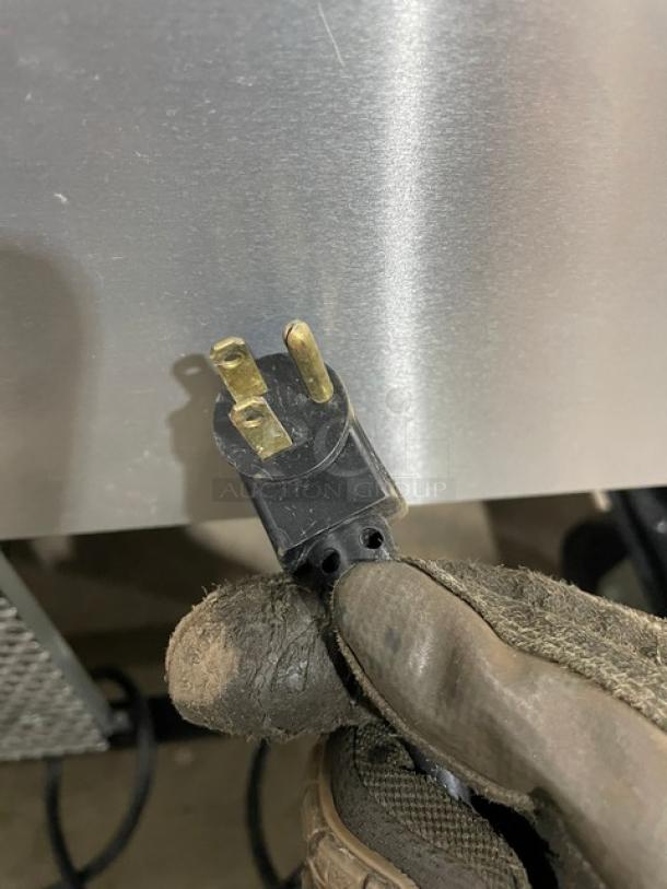 Stainless steel plug of a True TWT-60 worktop refrigerator, showcasing its 115V power connection.