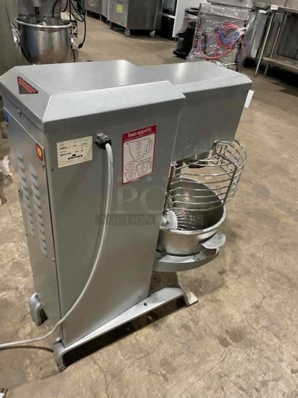 Univex SRM20 commercial electric mixer, 20 Qt., with stainless steel bowl guard, flat beater, whisk, and legs. 115V, 1 phase.