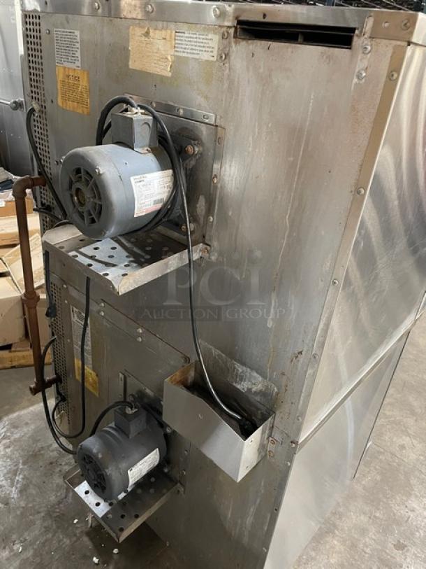 Southbend SilverStar stainless steel double stacked convection oven with thermostatic controls and wired rack, on legs.