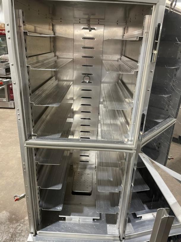 Cres-Cor stainless steel heated holding/proofing cabinet with solid Dutch doors, wide pan slides, and rubber bumper guard. On casters.