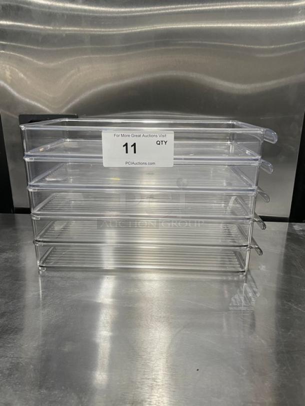 New lot of 11 clear polycarbonate rectangular food pans, commercial grade, stacked, labeled for auction, pristine condition.