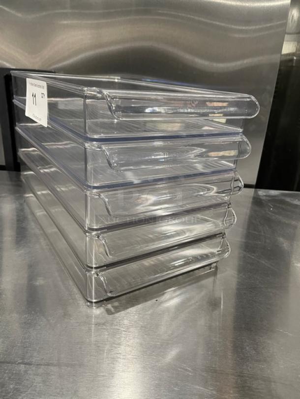Lot of new commercial clear polycarbonate rectangular food pans. Stack of six, durable, ideal for storage, pristine condition.