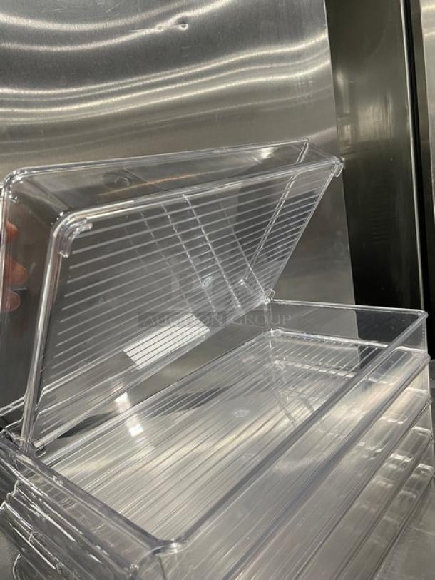 Lot of new commercial clear polycarbonate rectangular food pans, stackable design, durable and shiny appearance.