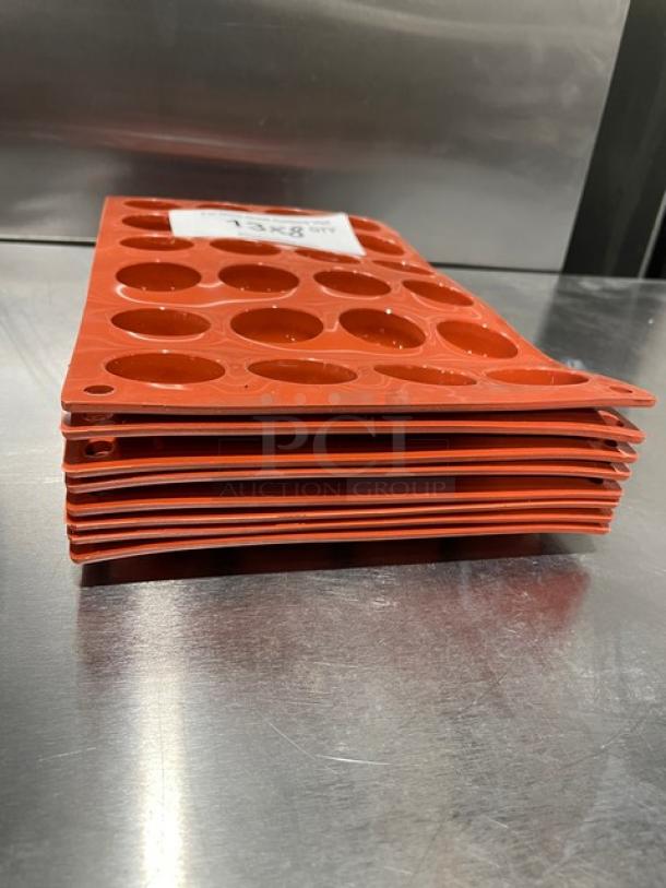 Silikomart Commercial 24-Cup Non-Stick Silicone Mould, new condition, stacked, orange color, label visible.