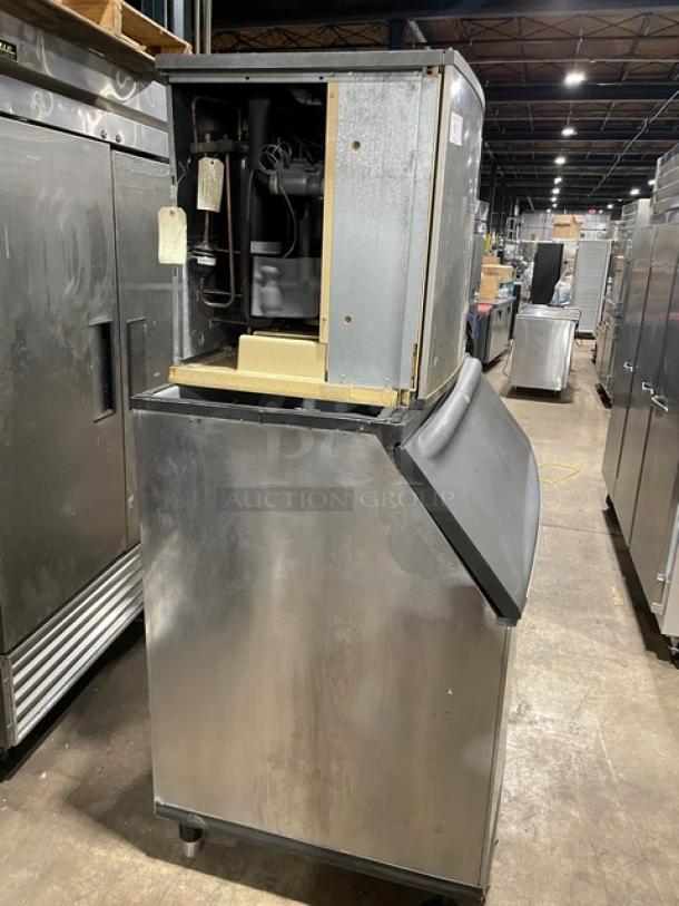 Manitowoc stainless steel ice machine model ID0892N-261, electric, on legs, storage bin included, industrial setting.