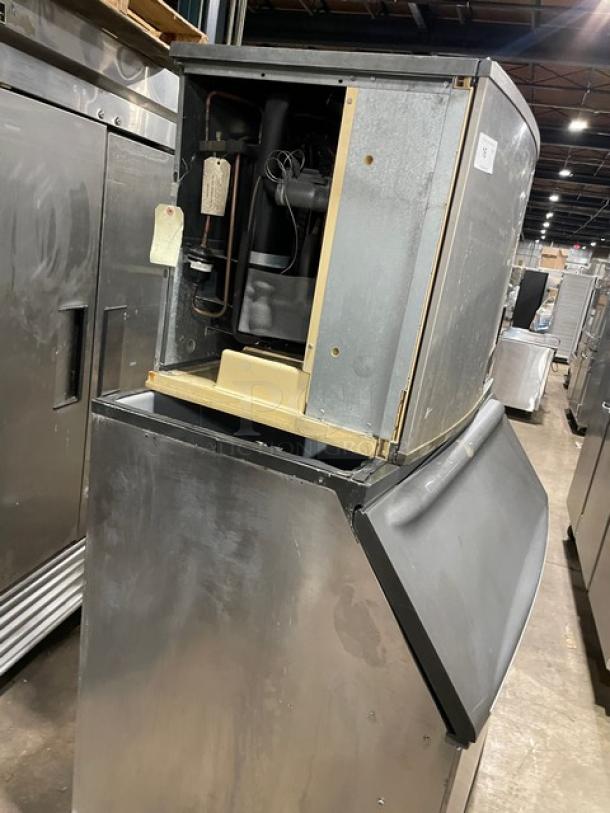 Manitowoc ID0892N-261 ice machine with storage bin, stainless steel, electric, 208-230V, 1 phase, on legs, visible internal components.