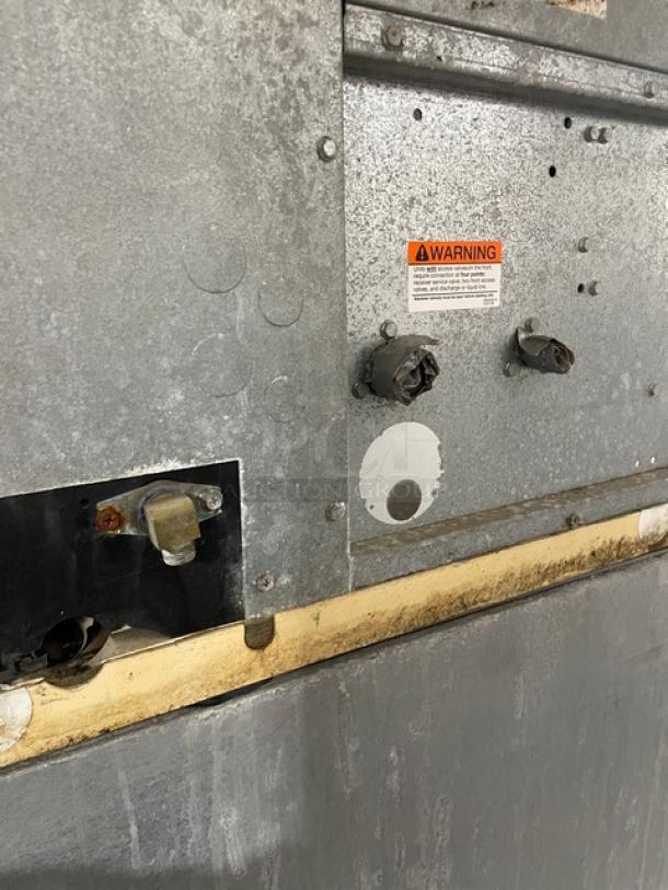 Manitowoc ID0892N-261 stainless steel ice machine, 208-230V 1 Phase, commercial use, on legs. Warning label visible.