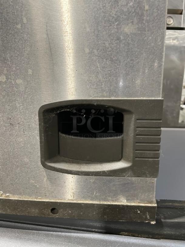Manitowoc stainless steel ice machine head/storage bin combo, model ID0892N-261, electric, on legs, visible handle detail.